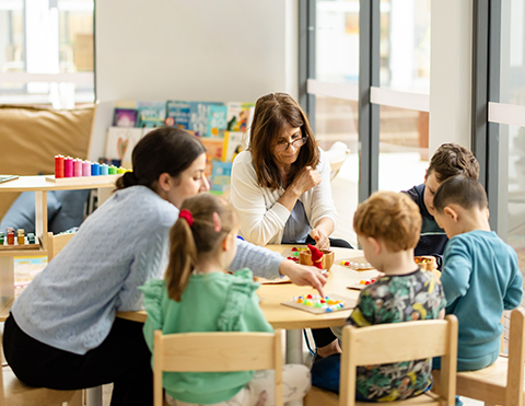 A warm educator playing with toddlers